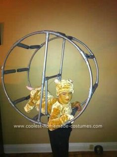 a person in a costume is holding a hamster wheel