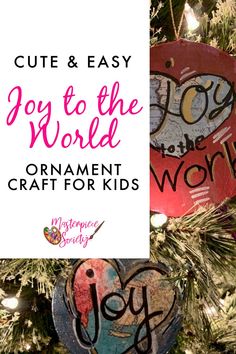 ornaments hanging from a christmas tree with the words joy to the world on them