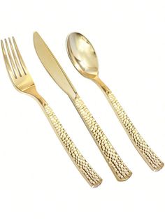 three forks, two spoons and one knife are on a white surface with gold colored handles