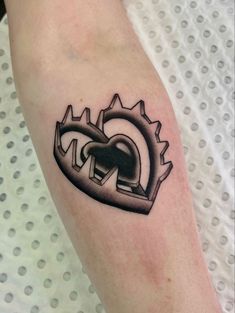 a black and white tattoo on the arm of a person with a wrench in it