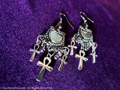 Vintage Ankh Mirror Earrings. - Upper metal ornament containing a real piece of mirror. - Ankh Symbols in 2 different sizes. - Silver colour. - Handmade. - Comes in a pair. Worldwide Shipping More jewellery, accesoires, altar equipment and much more can be found at www.luciferothica.com © Luciferothica.com All Rights Reserved. Vampire Ankh, Mirror Earrings, Ankh Symbol, Seal Gifts, Ear Weights, Silver Colour, Metal Ornament, Cross Charms, Gothic Jewelry