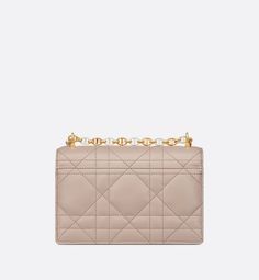 The Miss Caro mini bag enhances the Dior Caro line with modern and timeless elegance. Crafted in two-tone trench beige lambskin, it stands out with the unique quilted effect of Macrocannage stitching and a latte interior. The flap is accented by an antique gold-finish metal CD twist clasp inspired by the seal of a Christian Dior perfume bottle. Alternating between antique gold-finish metal links and trench beige enamel links, the adjustable chain shoulder strap has a latte leather insert for add Designer Quilted Beige Shoulder Bag, Luxury Quilted Beige Bag, Beige Quilted Evening Bag, Beige Quilted Evening Shoulder Bag, Luxury Quilted Cream Shoulder Bag, Elegant Beige Quilted Bag, Elegant Quilted Beige Bag, Caro Line, Dior Perfume Bottle