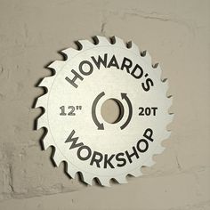 a circular saw blade with the words howard's workshop on it hanging from a wall