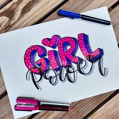 a piece of paper with the words girl power written on it next to some markers