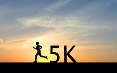 the silhouette of a man running in front of an orange and blue sky