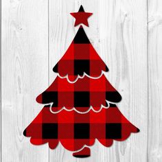 a red and black plaid christmas tree cutout on a white wooden background with stars