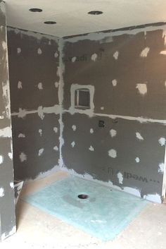 an unfinished bathroom is shown with the walls being painted gray and there are holes in the floor