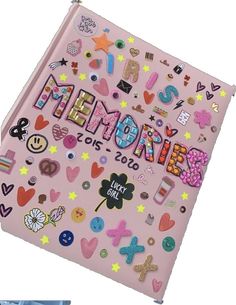 a pink book with lots of stickers on the front and back cover that says, happy new year