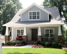 a gray house with white trim and windows