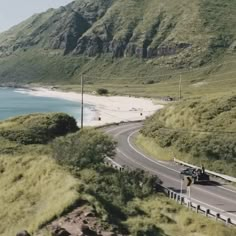 an aerial view of a road near the ocean