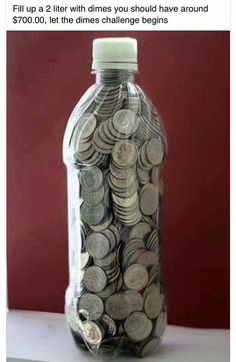 a bottle filled with coins sitting on top of a table