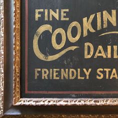 a framed sign advertising fine cooking daily