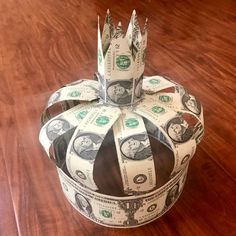 a crown made out of money sitting on top of a wooden table