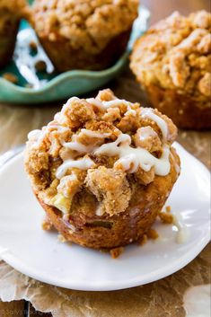 two muffins with icing on a white plate