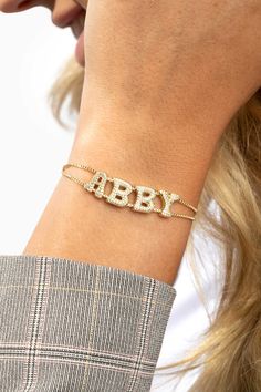 "14K Gold Plated Bubble Letters Name Bracelet, Personalized Gold Bracelet, Custom Name Jewelry, 14K Gold Plated Name Charms Bracelet.  * Material: High-quality and Anti Tarnish 14K Gold Plated - Brass; AAA Grade Cubic Zirconias. * Finish: Up to 5.75\" (14.5 cm) in diameter, adjustable 14K Gold Plated Box Chain.  HOW TO ORDER * Leave us your name or word in the PERSONALIZATION column when ordering. * Design can be personalized with your NAMES, INITIALS, or WORDS. * Please refer to the last picture for available charms. OTHER INFORMATION * All custom jewelry is nicely packaged and ready to gift in handmade and elegant jewelry packaging. TURN AROUND TIME * All personalized jewelry is custom-made to order. Our production time is about 1-2 business days. This    can change during peak seasons. Bubble Bracelet, Personalized Gold Bracelet, Bubble Font, Name Bracelets, Retro Bracelet, Gold Armband, Bubble Letters, Charms Bracelet, Dope Jewelry