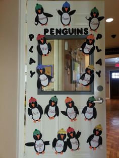 a door decorated with penguins and the word penguin on it's side, in front of a mirror