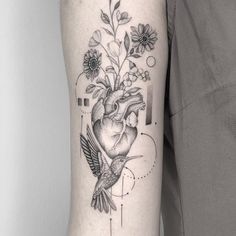 a black and white photo of a heart with flowers on it's side arm