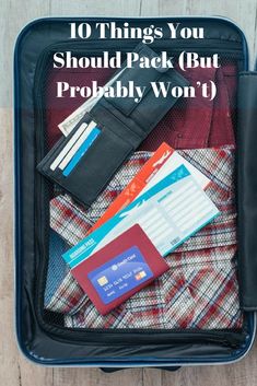 an open suitcase with passport, wallet and credit cards on it text reads 10 things you should pack but probably won't