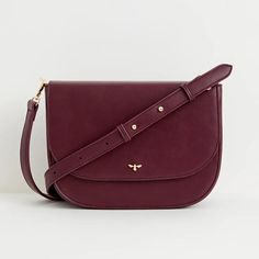 A thoughtfully designed, spacious messenger bag crafted from certified vegan leather in a rich burgundy. This bag strikes the perfect balance between style and utility, making it a versatile choice for both work and casual use. It features an adjustable cross-body strap, a convenient zipped inner pocket, and a secure magnetic fastening to ensure your essentials are well-protected. We also have the same bag in tan, and a smaller saddle bag in the same colourways Key features: Approx. 29 (L) x 21 Office Burgundy Shoulder Bag With Adjustable Strap, Burgundy Crossbody Shoulder Bag For Office, Classic Burgundy Shoulder Bag With Adjustable Strap, Luxury Burgundy Shoulder Bag With Adjustable Strap, Versatile Satchel Saddle Bag For Work, Business Shoulder Bag With Detachable Strap In Burgundy, Burgundy Business Shoulder Bag With Detachable Strap, Versatile Saddle Bag With Adjustable Strap For Work, Burgundy Shoulder Bag Satchel With Adjustable Strap