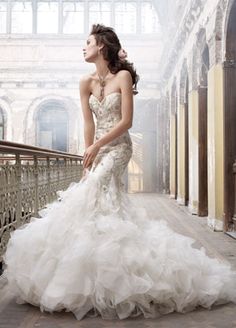 a woman in a wedding dress standing on a balcony with her hands on her hips