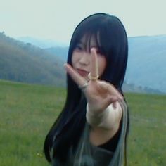 a woman with long black hair making the vulcan sign