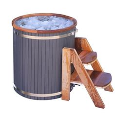 an outdoor hot tub with wooden steps next to it