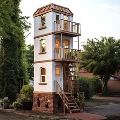 a tall white tower with stairs leading up to the upper floor and second story windows