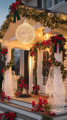 christmas decorations on the front porch of a house with lights and wreaths around it