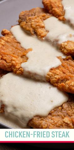 chicken fried steak covered in gravy on a plate with the words, chicken fried steak