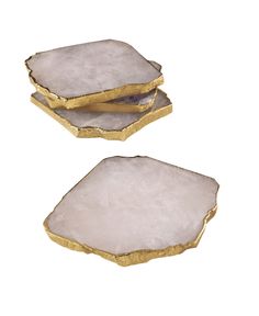 two small white and gold trays on top of each other, one with an irregular shape