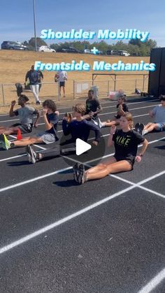 a group of people sitting on top of a race track with their feet in the air