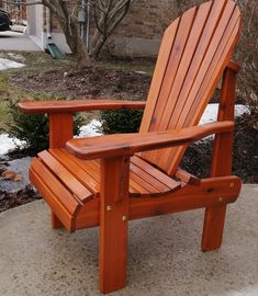 a wooden chair sitting on top of a sidewalk