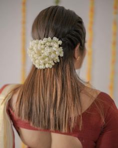 the back of a woman's head with flowers in her hair and an instagram