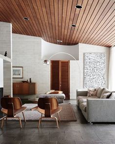 a living room filled with furniture and wooden ceilings