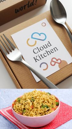 a bowl of noodles and a fork on a table with a sign that says cloud kitchen