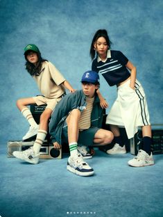 three young people sitting on top of suitcases in front of a blue background,