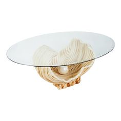 a glass and wood table with an artistic design on the top that is shaped like a heart