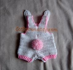 a crocheted baby's bib and diaper cover on a bed