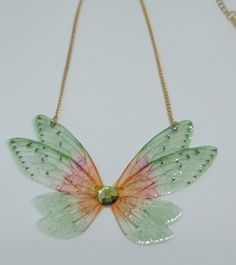 Discover the new magnificent collection of resin fairy wing necklaces. They have been created with love to add a magical and magical touch to your day! *The fairy wing necklace was created by me in my magical workshop. The necklace has a stainless steel chain adjustable by an extension chain. These high-end jewelry pieces are both elegant and durable. *The magical and magical fairy wings are made from resin which is a delicate but sturdy material once hardens. A certain light and shine has been Handmade Whimsical Butterfly Necklace, Whimsical Handmade Butterfly Necklace, Whimsical Resin Jewelry For Party, Fairycore Butterfly Necklace As A Gift, Fairycore Butterfly Necklace For Gift, Fairycore Butterfly Necklace Gift, Iridescent Fairy Jewelry For Parties, Iridescent Fairy-style Jewelry For Parties, Whimsical Butterfly Charm Jewelry For Party