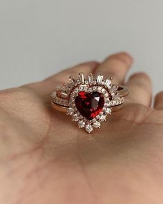 Heart Shape Ruby Diamond Engagement Ring, Halo Diamond Ring, Curved Wedding Band, Trio Ring Set, 14K Solid Gold Ring, Valentine Day Gift Diamond-Cubic Zirconia/Moissanite Main Diamond Cut- Heart Cut  Side Diamond Cut - Tapered Baguette Cut Metal Customization: White gold: 10k/14k/18k yellow gold: 10k/14k/18k rose gold: 10k/14k/18k silver: 925 sterling silverC O N T A C T US ~ if you would like to make custom rings - We ship worldwide & we make sure that you get your shipment as earliest as possible provided there is no delay in customs clearance, public holiday, courier location, or circumstance which is beyond human control. ~ We don't charge any sales tax on any sales made internationally. You will be responsible for all import duties in your country. ~ Shipping fees are not refundable u Luxury Ruby Ring, Rose Wedding Ring, Ruby Diamond Engagement Ring, Trio Ring Set, Garnet Wedding Rings, Trio Ring, Ring Proposal, Cute Engagement Rings, Curved Wedding Band