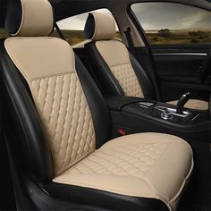 the interior of a car with beige leather and black stitching on the front seats