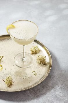 a glass filled with liquid sitting on top of a metal tray