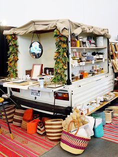 a food truck parked on the side of a road with lots of baskets in front of it