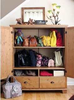 a wooden shelf filled with lots of purses next to a bag and handbag