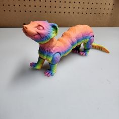 a colorful toy lizard sitting on top of a table