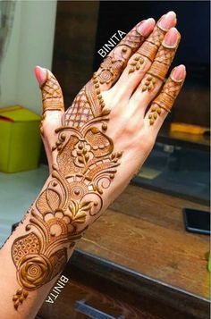 two hands with henna tattoos on them