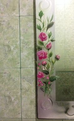 a bathroom mirror with pink flowers painted on it