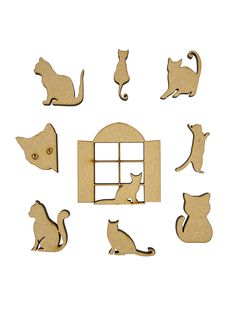 wooden cutouts of cats sitting in front of a window