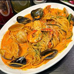 a white plate topped with pasta and clams