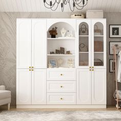 a living room with white furniture and a chandelier